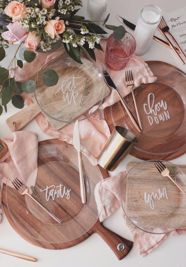 Hand lettered plate DIY, clear glass plates lettered in white script over wooden boards with pink linen napkins