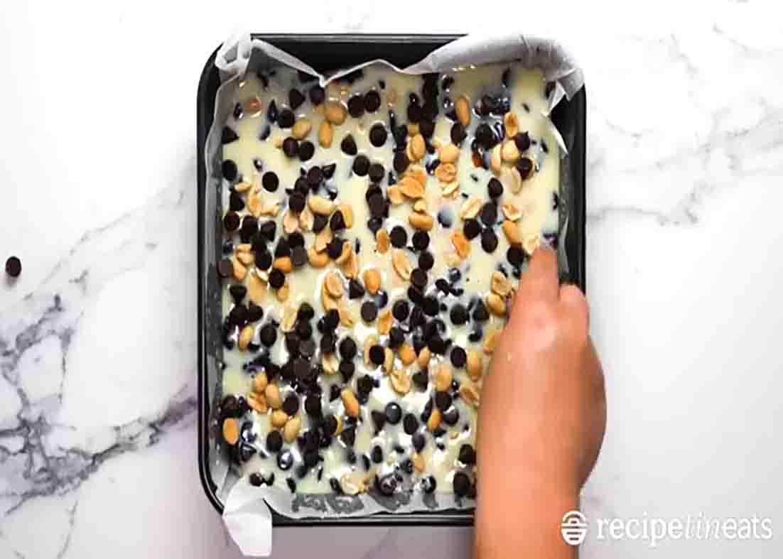 Adding the topping of the chocolate nut bars