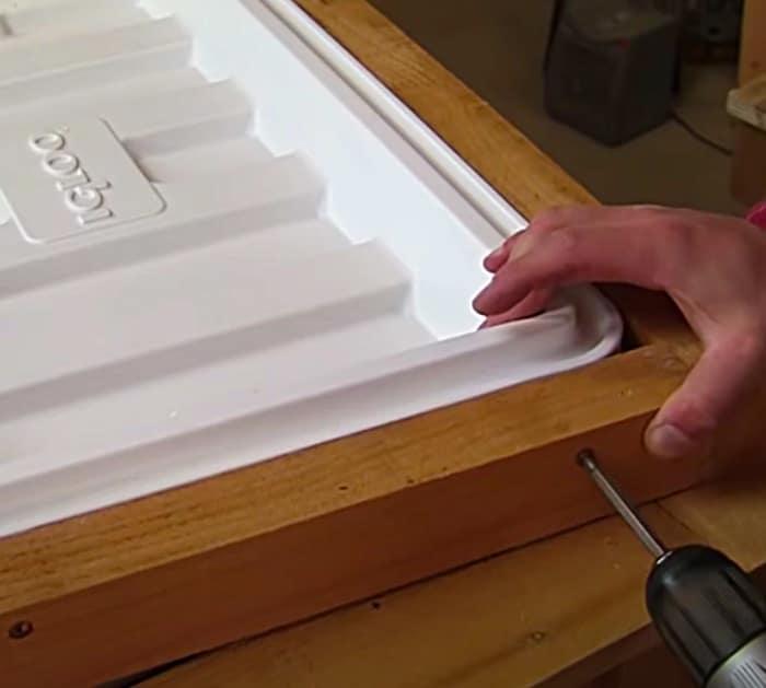 DIY patio cooler made of wood with an Igloo ice chest