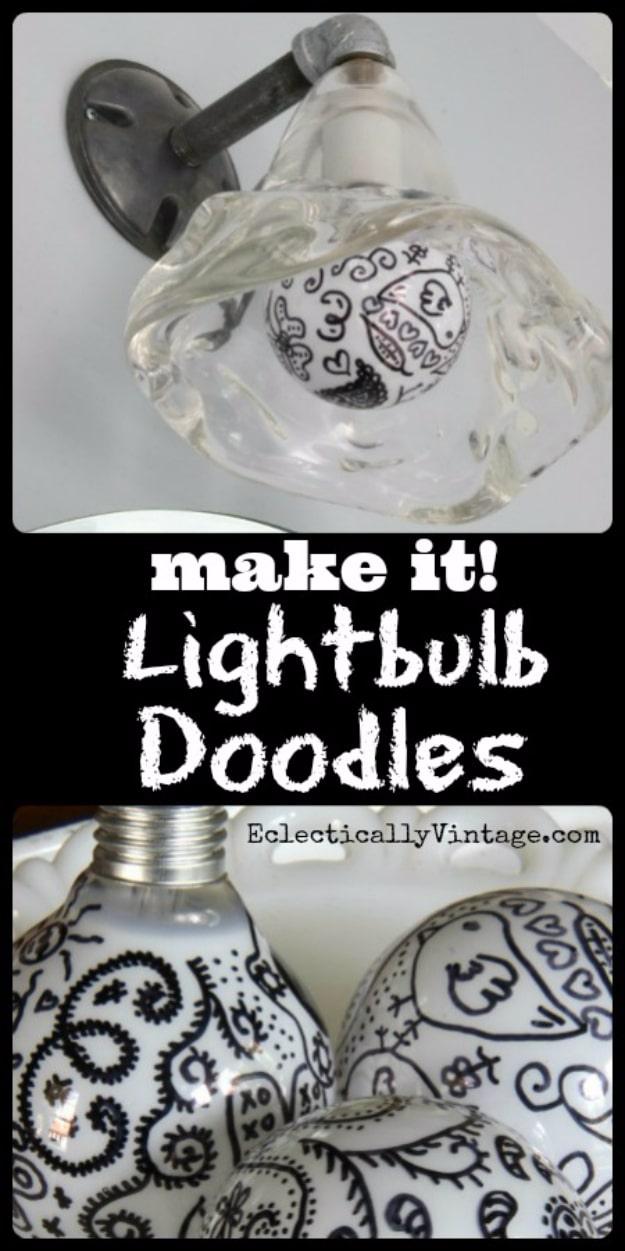 Lightbulb doodles graphic, clear and white lightbulbs covered in black paisley doodles, one fitted in a wall sconce