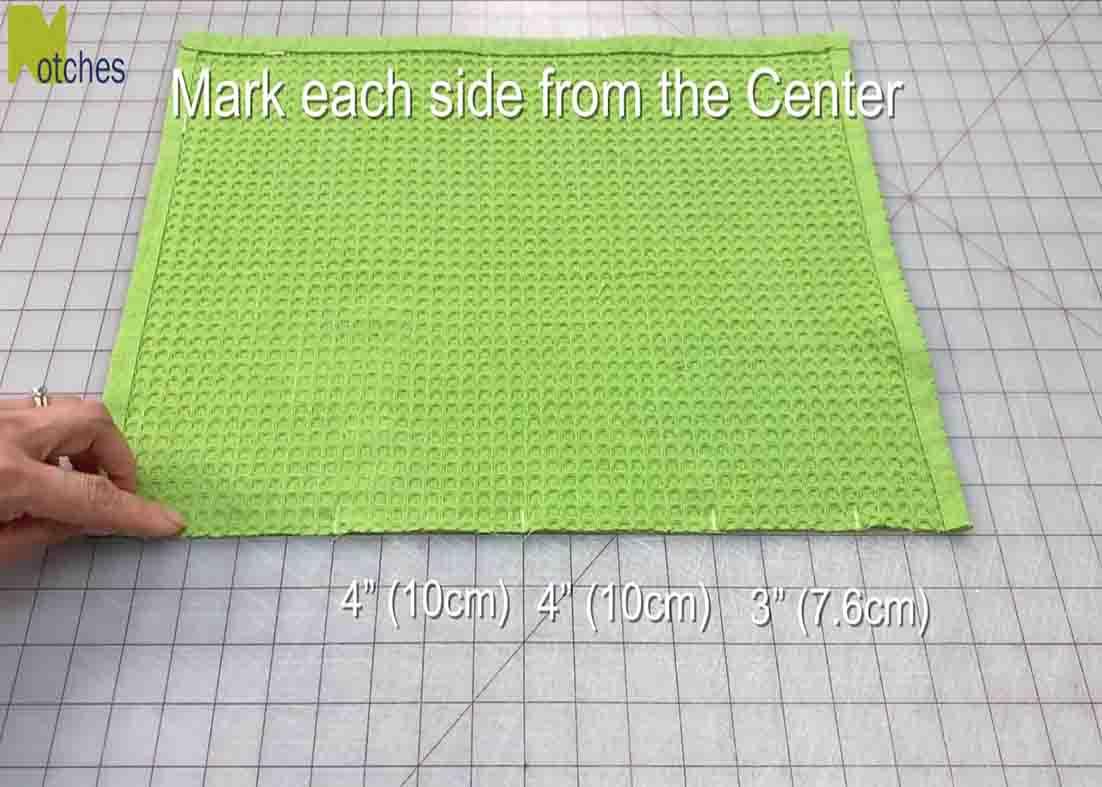 Cutting the tea towel in half