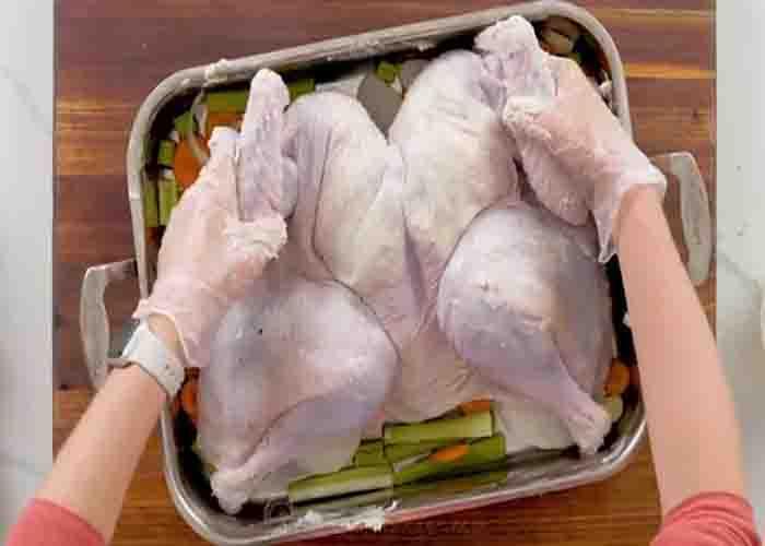 Placing the spatchcock turkey in the roasting pan