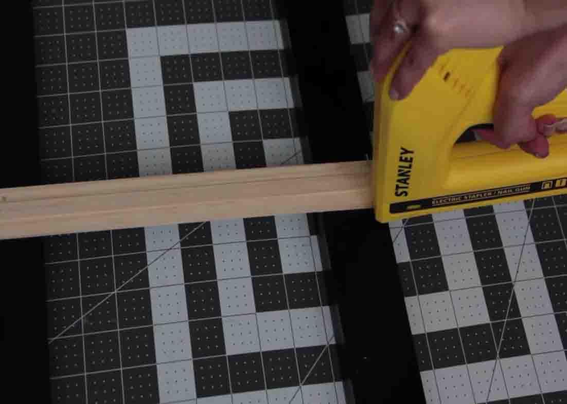 Attaching the ruler to the wooden plaques to make the Dollar Tree basket organizer