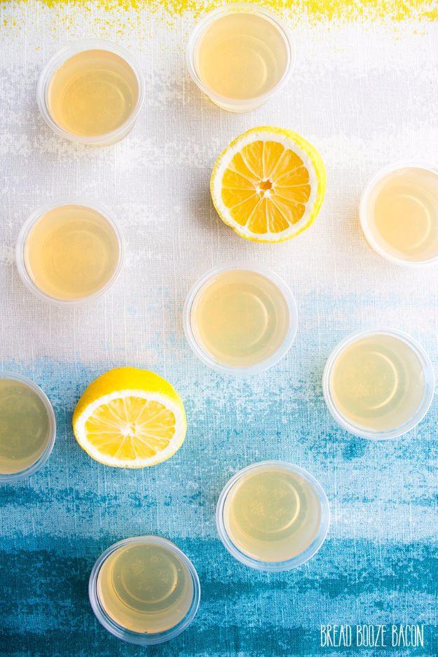 Arnold Palmer jello shots in two ounce cups showing a pale lemonade layer under a darker iced tea layer