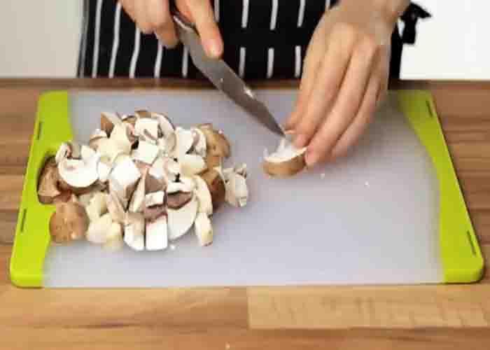 Chopping the mushrooms for the mushroom and potato stew recipe