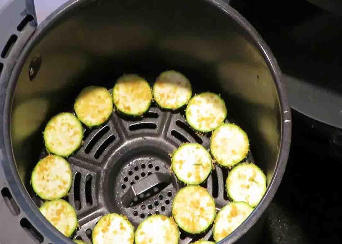 Laying the zucchini in the air fryer basket