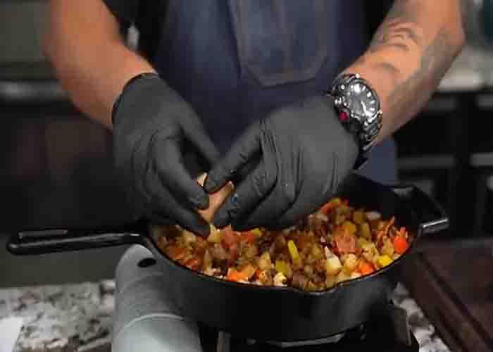 Adding the eggs to the breakfast skillet