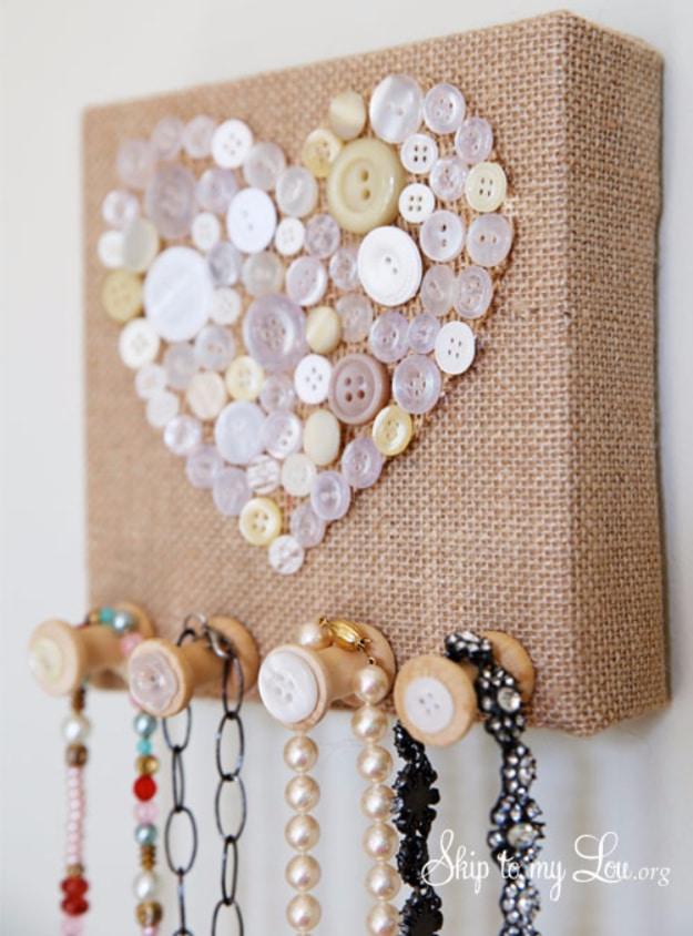 Burlap stretched in a thrifted frame with vintage buttons as the hooks, necklaces hanging in soft country style