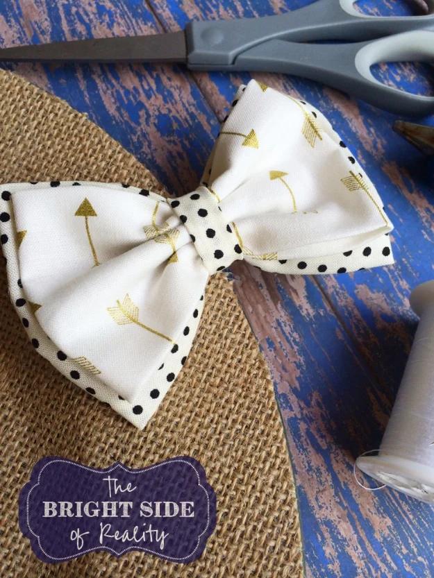 A rainbow row of small cotton fabric bows on alligator clips laid across a white board, sweet Etsy shop ideas for kids
