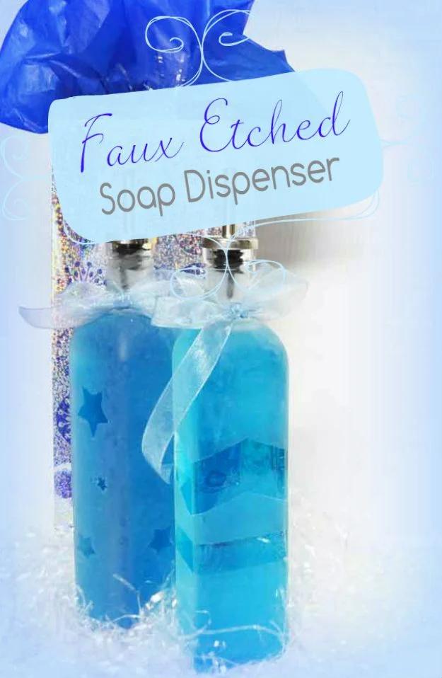 Two faux etched glass soap dispensers with blue soap and white frosted stripes wrapped in ribbon as a gift set