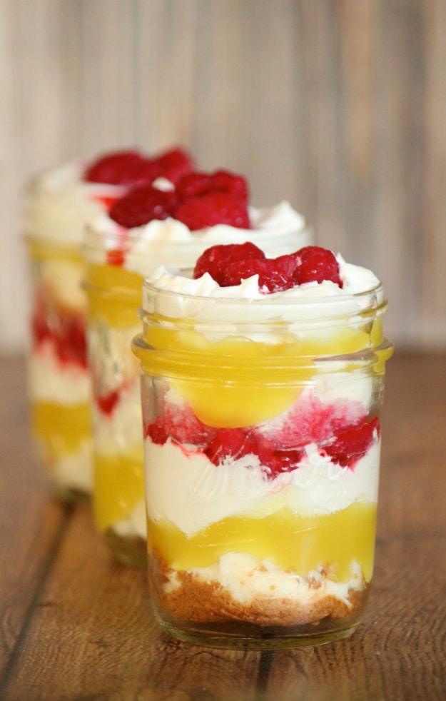 Lemon raspberry trifle jars layered with angel food cake discs, lemon curd, whipped topping and raspberries