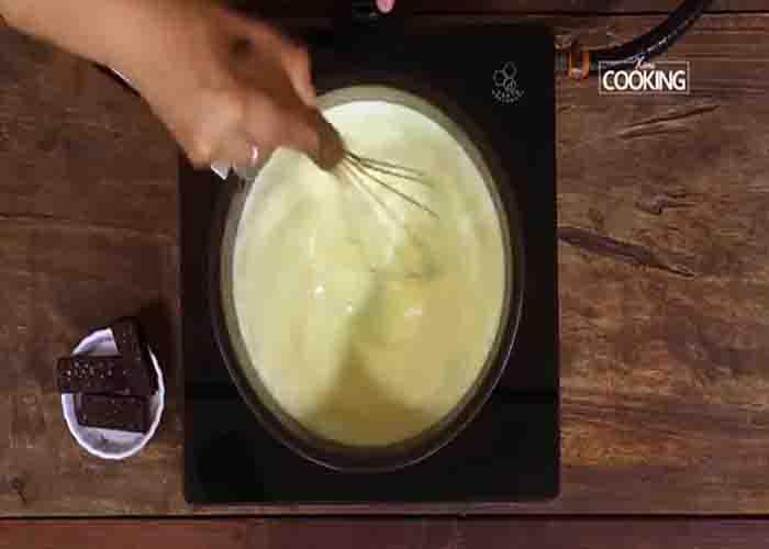 Making the custard for the custard biscuit pudding