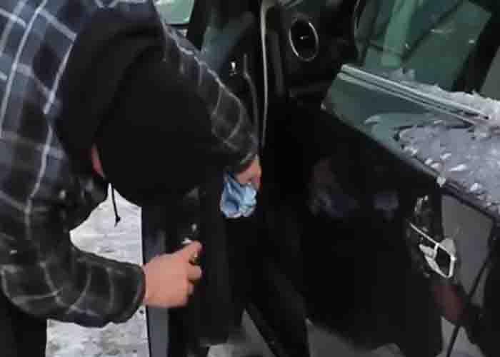 Applying WD-40 to the car door to keep it form freezing