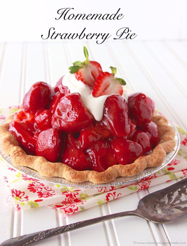 Homemade strawberry pie in a fluted crust filled with glazed whole strawberries and topped with whipped cream