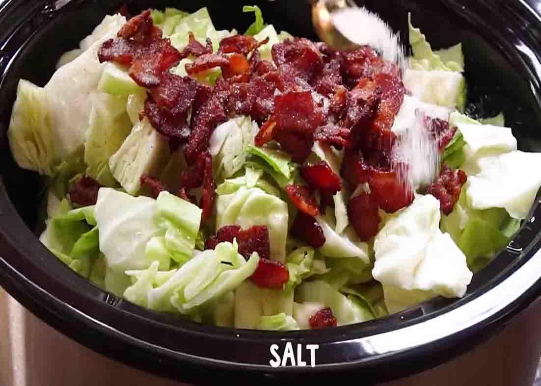Putting all the ingredients in the slow cooker for the cabbage with bacon recipe