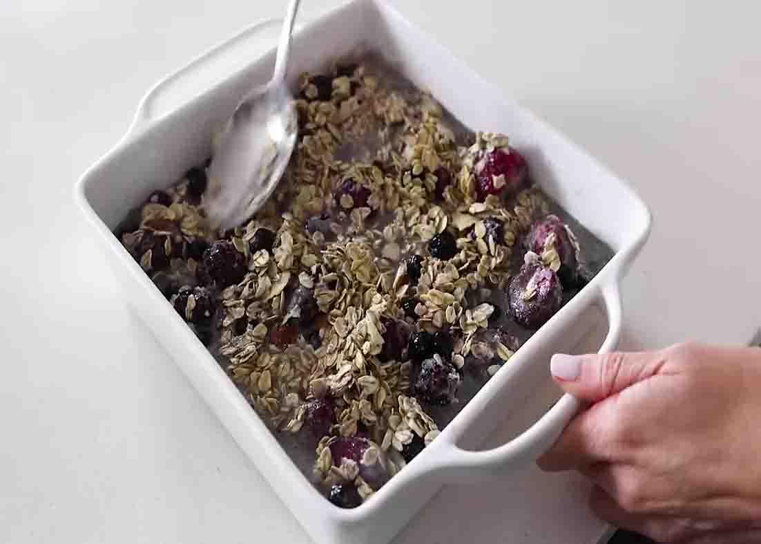 Pouring the berries mixture into the baking dish
