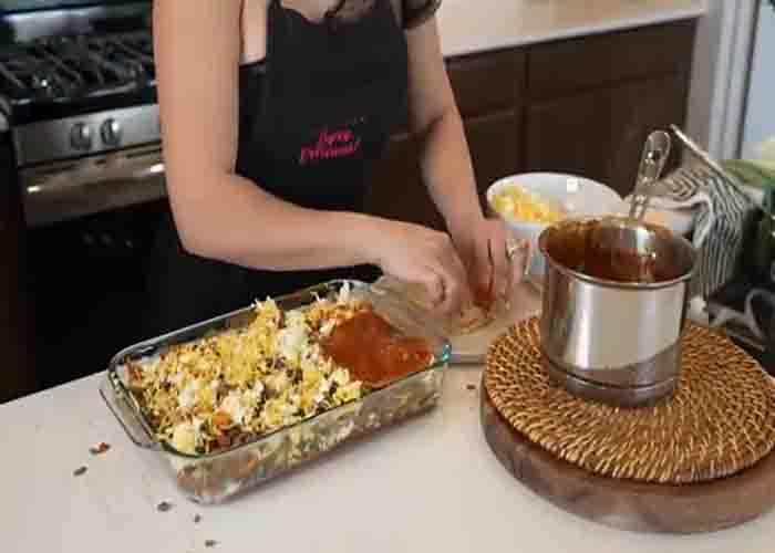 Layering the cheesy beef enchilada casserole