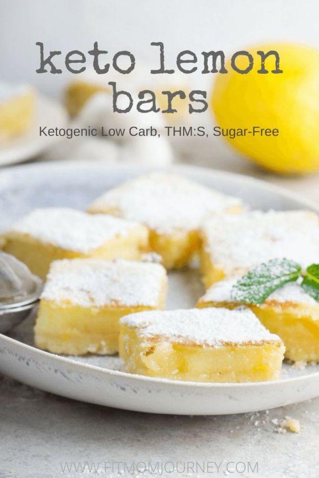 Keto lemon bars pin graphic with pale yellow bars dusted white on a plate with mint, a lemon and a title block