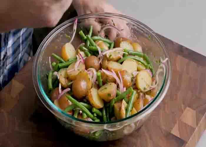 Tossing the potato green bean salad