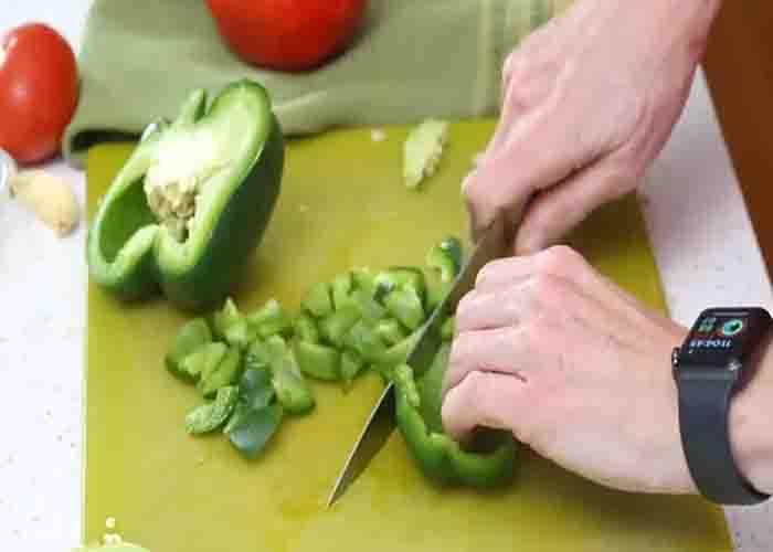 Chopping the bell peppers for the stuffed pepper skillet recipe