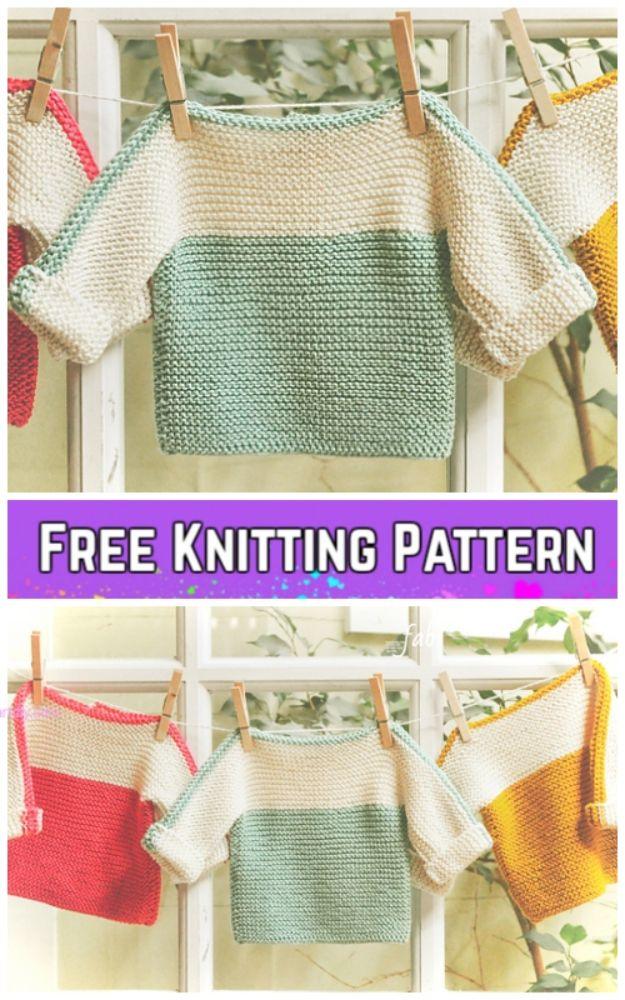 Three garter stitch baby pullovers in green, coral and yellow with contrast sleeves, pegged on a line indoors