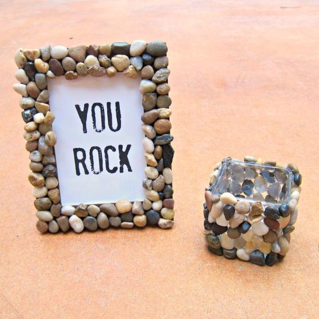 A rustic picture frame covered in small smooth stones holding a photo, a handmade Valentine gift for him