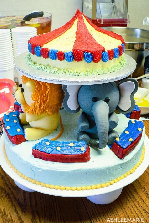 Two tier circus baby shower cake with a red and yellow striped big top and fondant lion and elephant figures