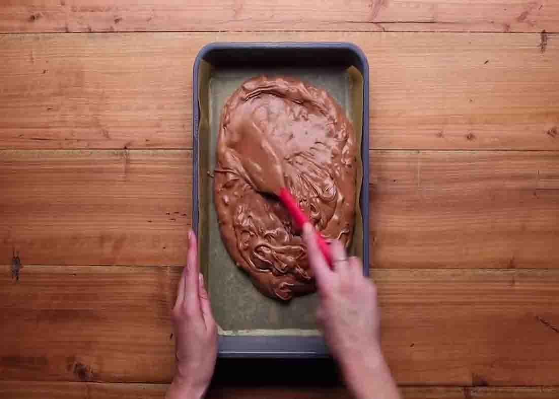 Smoothing the top of the brownie batter on the baking pan