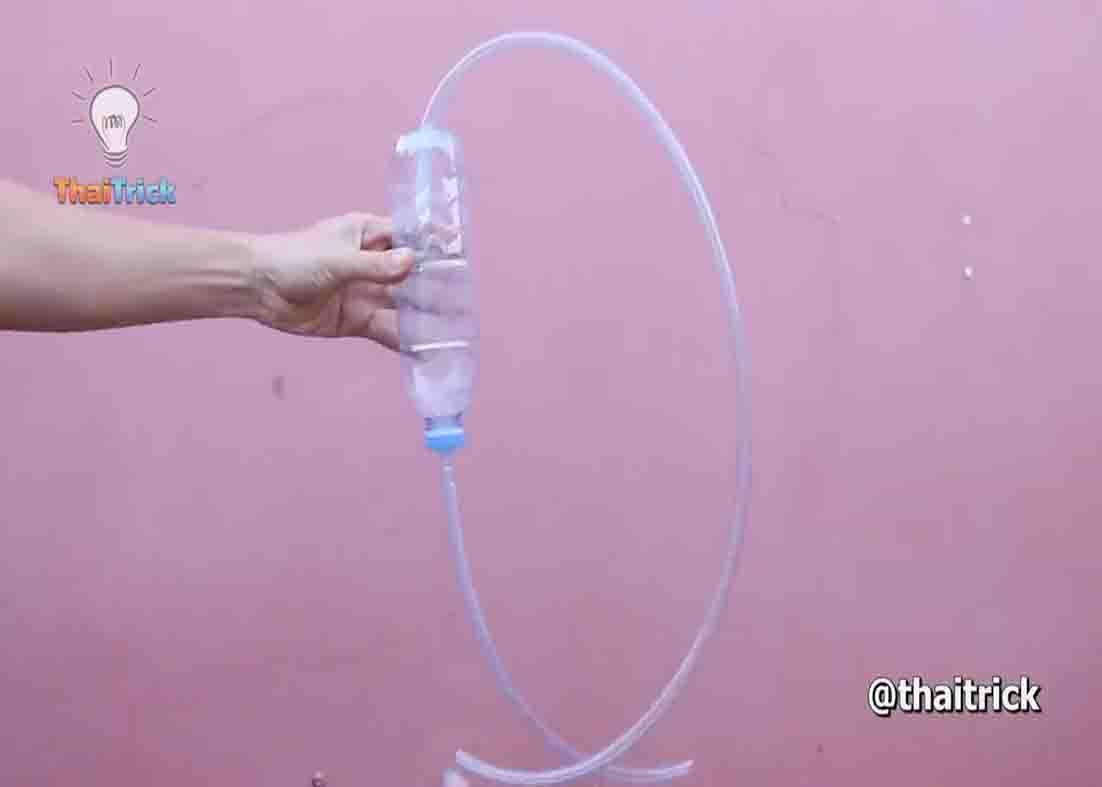 Plastic bottle recycled as a siphon