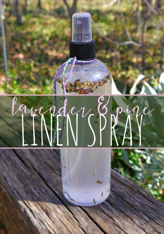 Spray bottle of lavender and pine linen spray with sprigs inside, photographed on weathered wood outdoors