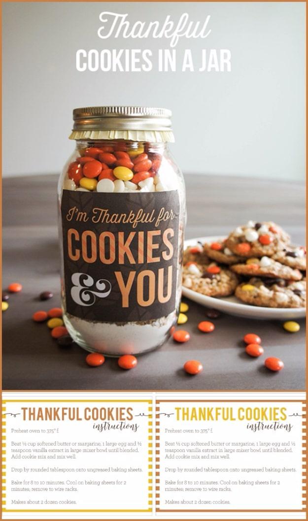 Mason jar of thankful cookie mix with orange and brown candies and a printed fall label on the front