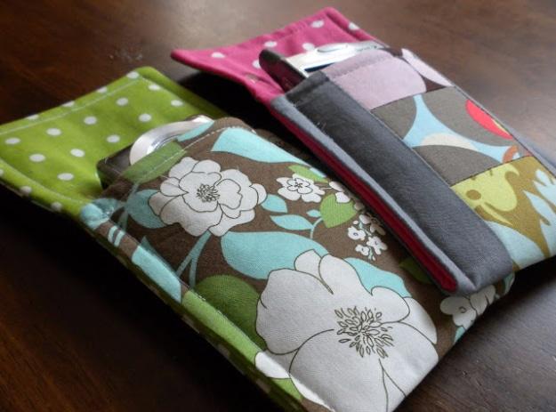 A padded gadget sleeve in gray print cotton holding a phone, velcro flap open, lined with fleece cut from offcuts