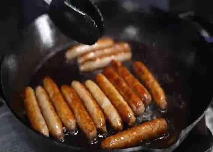 Frying the sausages for the breakfast skillet