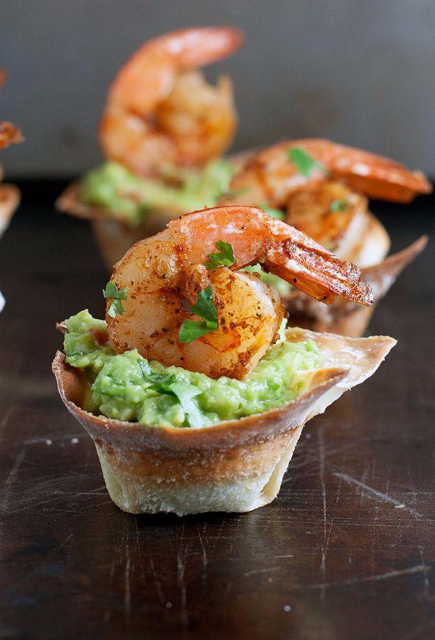 Guacamole shrimp wonton cups, crisp baked wonton shells filled with guacamole and topped with Cajun shrimp