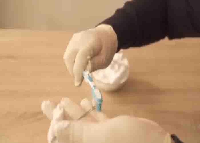 Brushing the jewelry with shaving foam to clean it