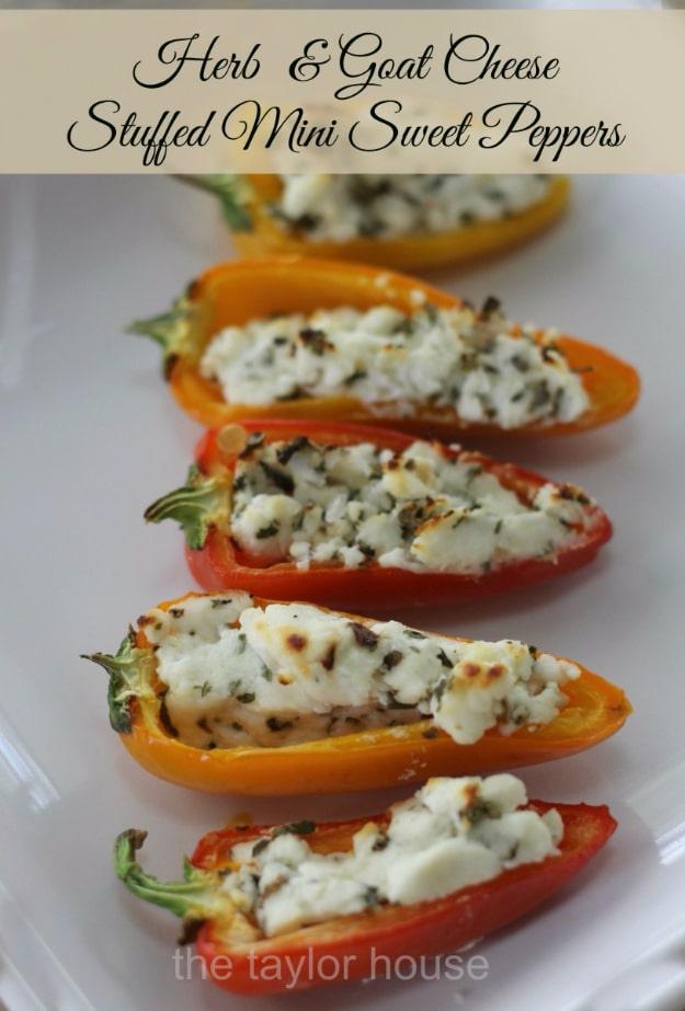 Herb and goat cheese stuffed mini sweet peppers baked until their edges brown on a parchment lined sheet pan