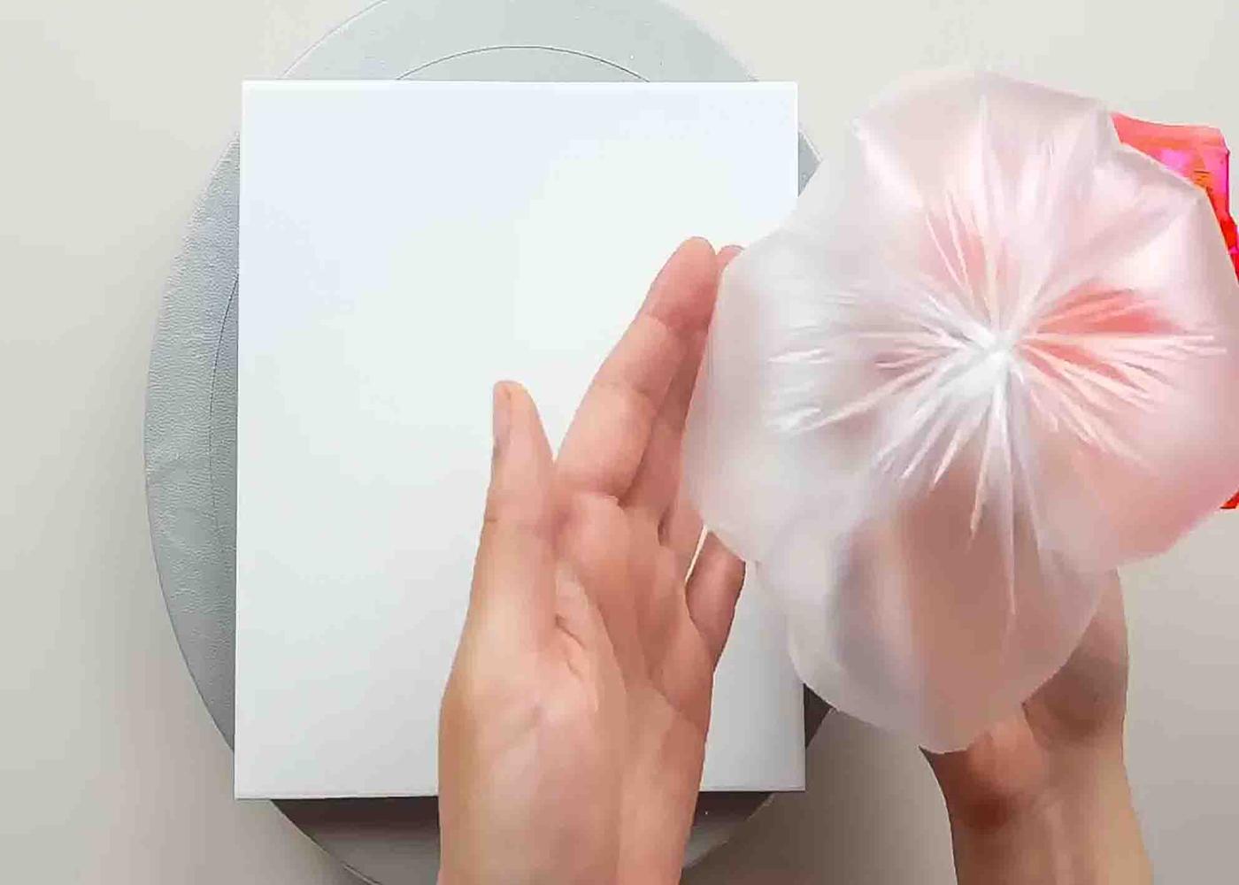 Preparing to paint flowers using a plastic bag