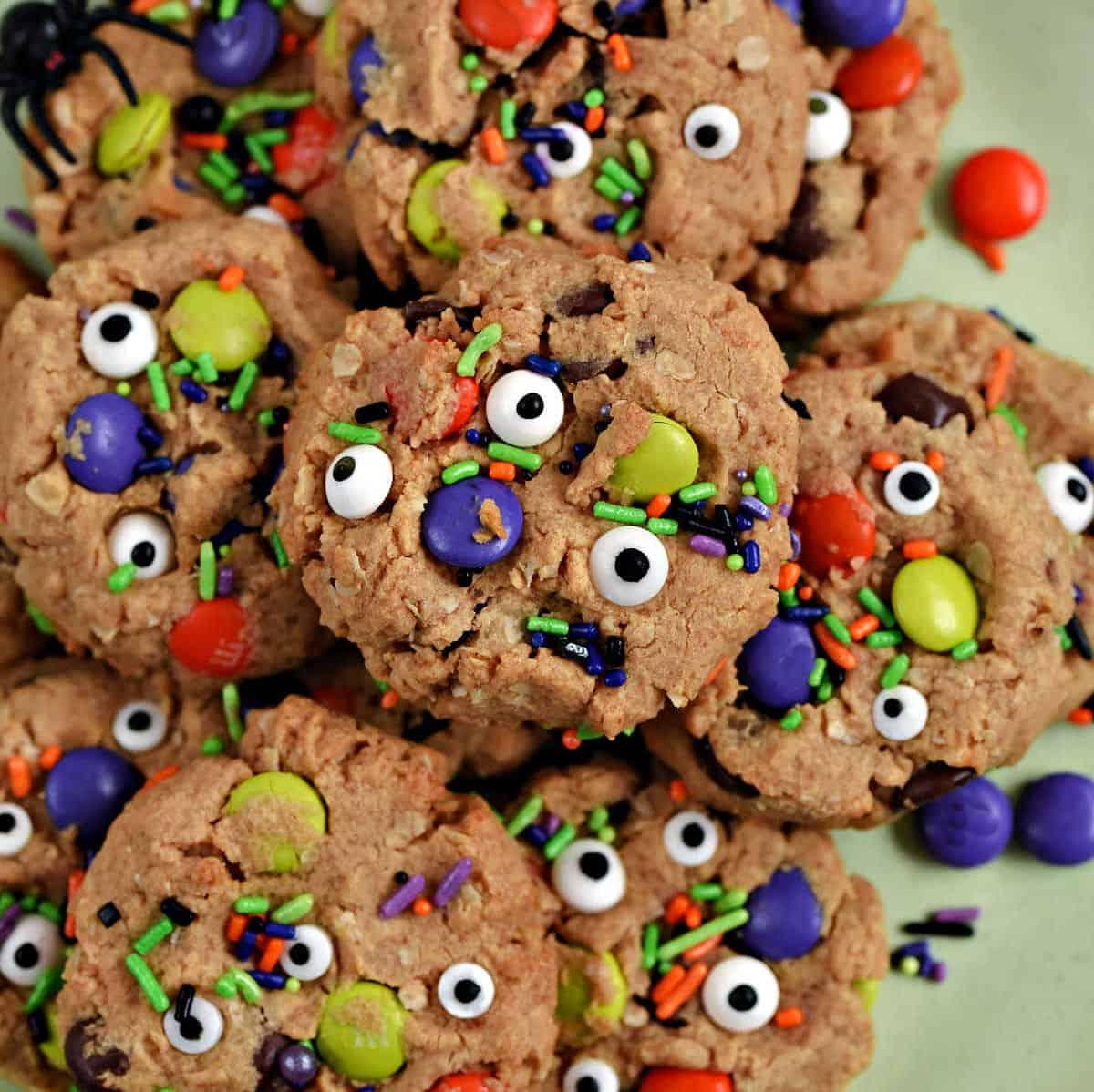 Oatmeal monster cookies loaded with colorful candy pieces, chocolate chips and assorted candy eyes for Halloween