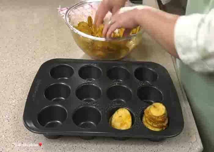 Stacking the potatoes in the muffin pan