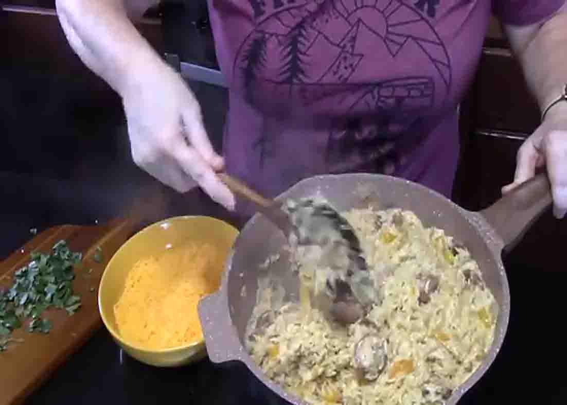 Finishing the smoked sausage and cheesy rice skillet