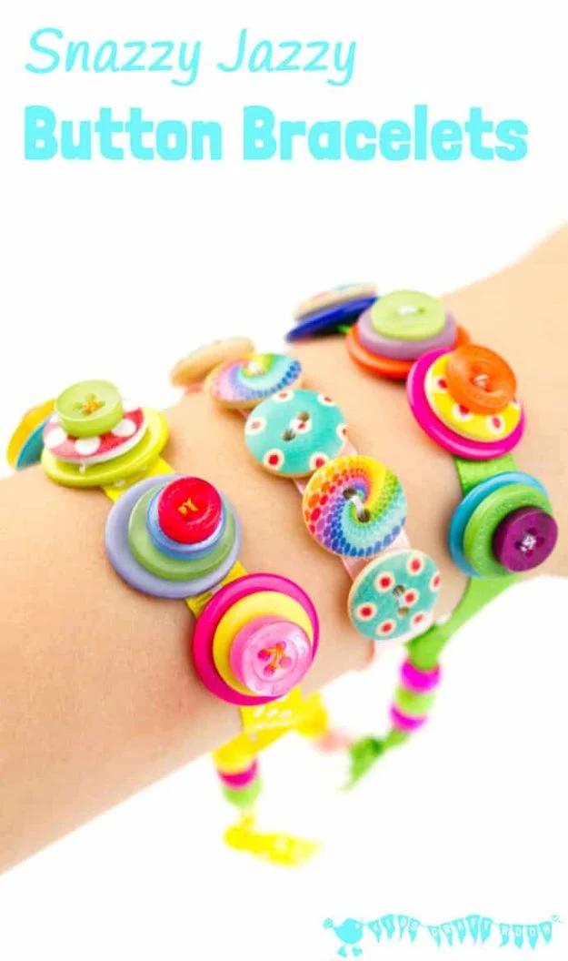 Bright button bracelets made from stacked mismatched buttons sewn onto ribbon, worn along a child's wrist