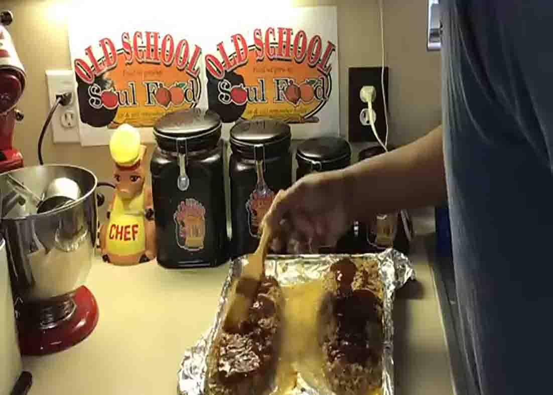 Brushing the sauce over the meatloaf