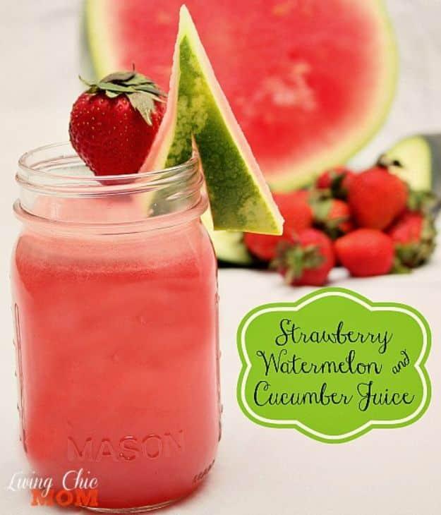 Strawberry watermelon and cucumber juice in a mason jar with a watermelon wedge and a strawberry on the rim