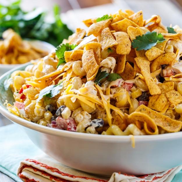 BBQ ranch pasta salad with black beans, corn, red pepper, cheddar and crushed corn chips on top for an outdoor barbecue