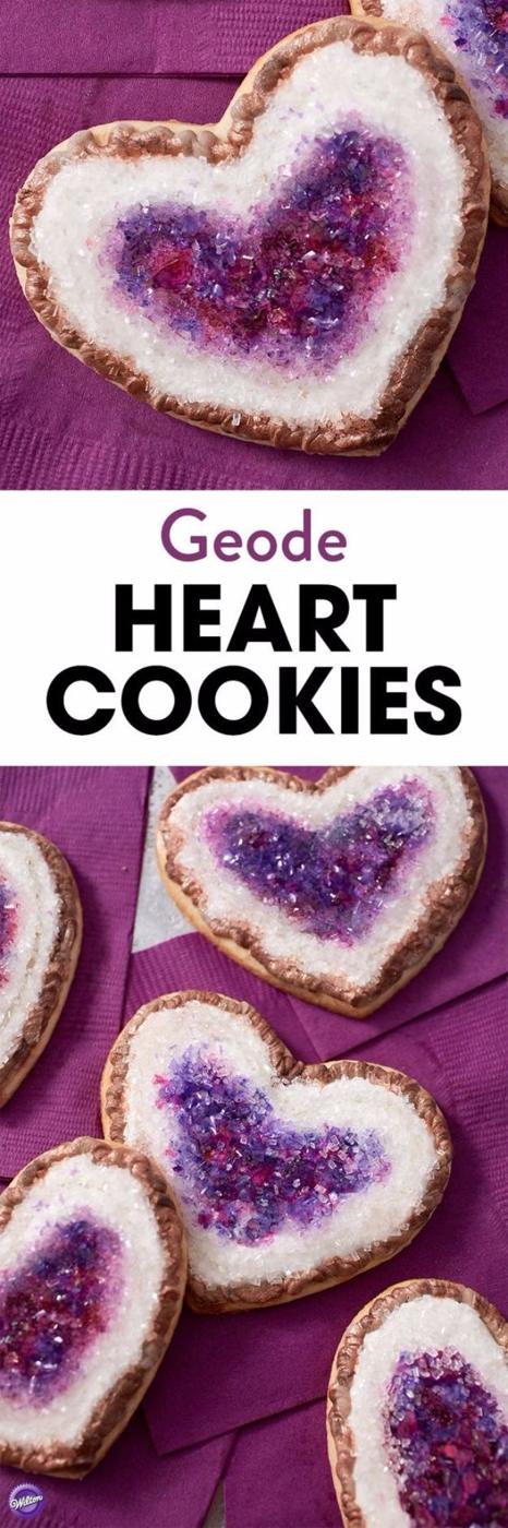 Geode heart cookies with purple rock candy crystals set into white icing edged with a jagged brown border
