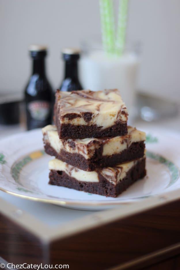 Irish cream cheesecake brownies with a marbled swirl top, cut into squares, a rich easy dessert idea