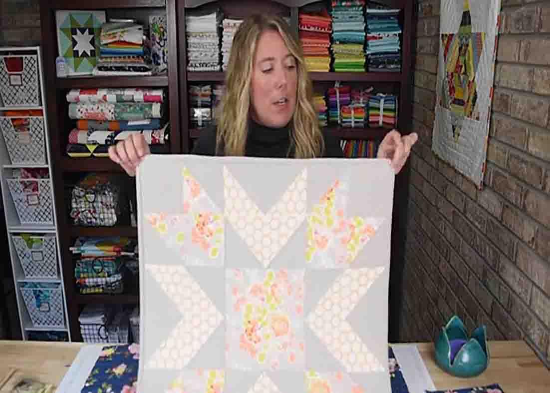 Using thumbtacks to hang a quilt
