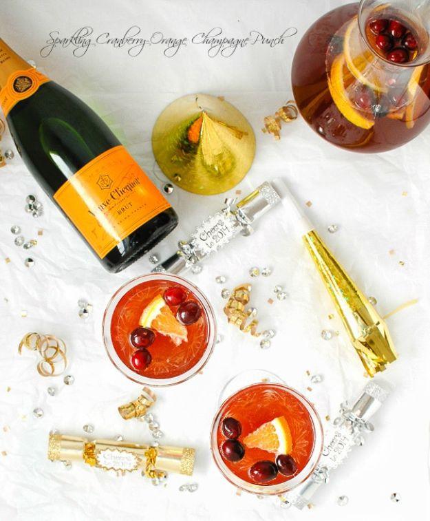 Script band reading Sparkling Cranberry-Orange Champagne Punch above a flat lay with a bottle and a pitcher