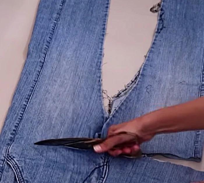 Make a long denim woman's vest out of a large pair of men's jeans