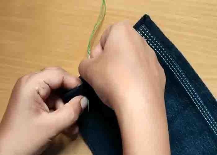 Starting to stitch a hidden or ladder stitch on the fabric